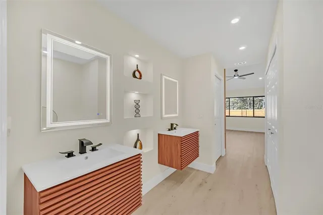 a bathroom with a bathtub sink and mirror