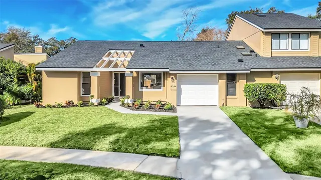 a front view of a house with a yard and garage
