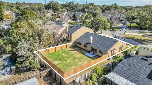 an aerial view of a house with a yard