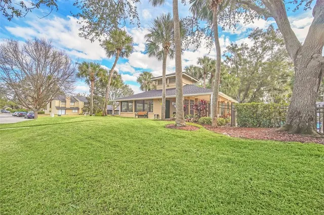 a front view of house with yard and green space