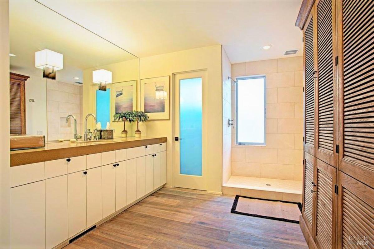 55 West Shore Road Belvedere, CA 94920 - Photo 11 of 16 a spacious bathroom with a sink and a mirror