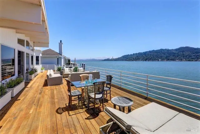 a view of a balcony with two chairs and a table
