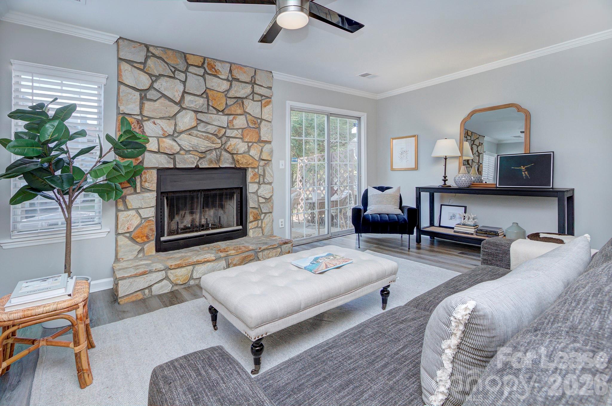 8268 Golf Ridge Drive Charlotte, NC 28277 - Photo 11 of 24 a living room with furniture a fireplace and a potted plant
