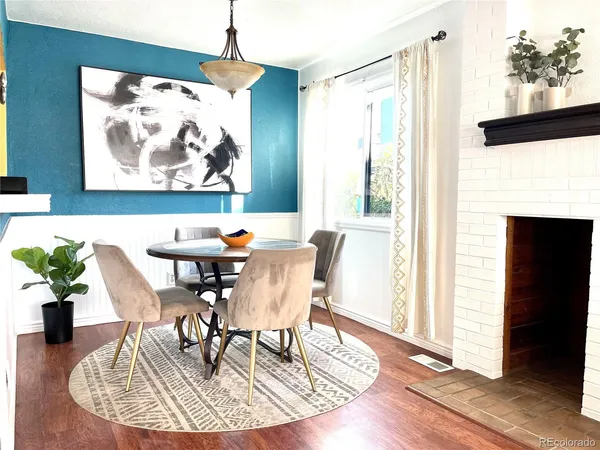 a dining room with furniture potted plants and wooden floor