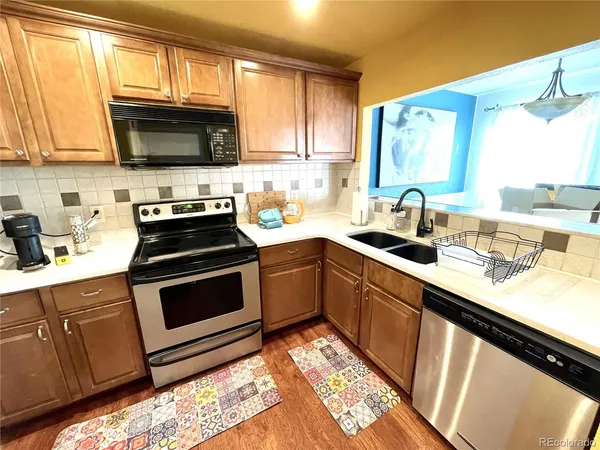 a kitchen with stainless steel appliances a sink dishwasher stove microwave and cabinets