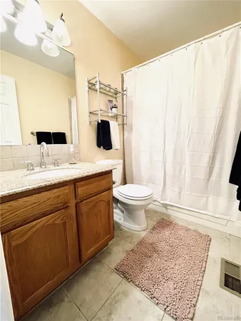 a bathroom with a sink toilet a mirror and vanity