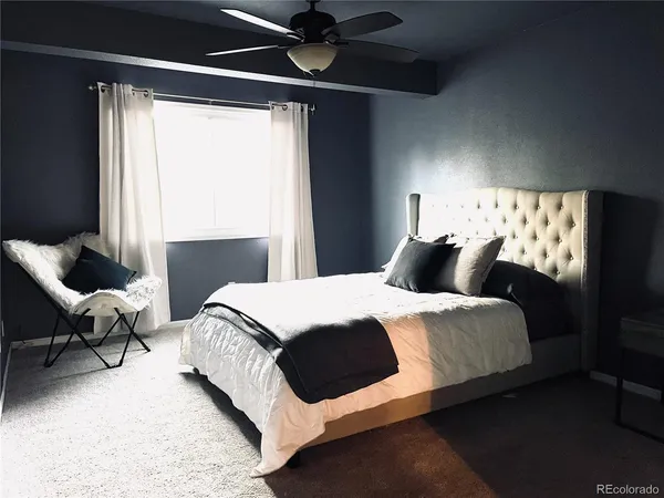 a bedroom with bed and a window