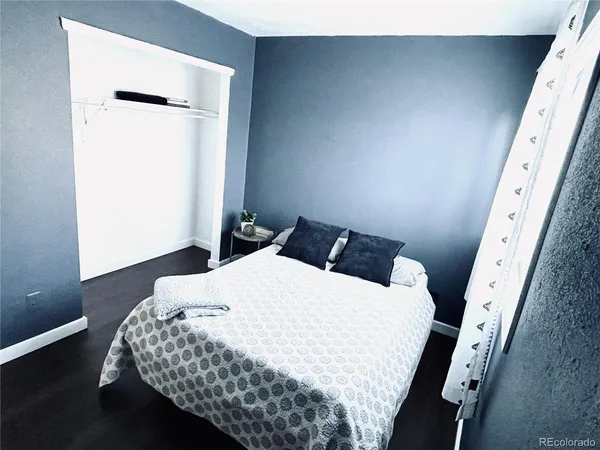 a bedroom with a bed and a mirror