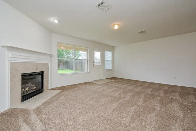 a view of empty room with a fireplace