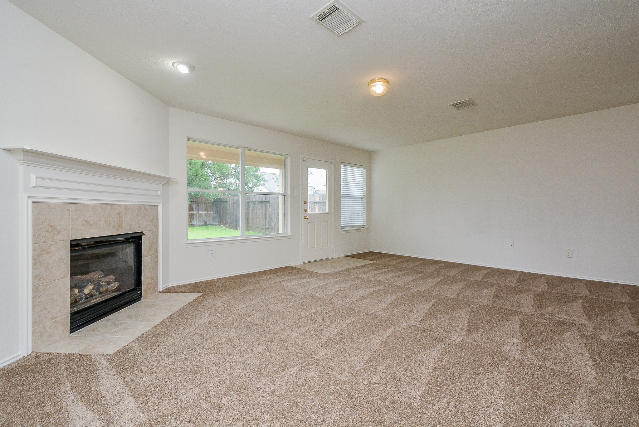 18326 Thicket Grove Road Houston, TX 77084 - Photo 11 of 50 a view of empty room with a fireplace