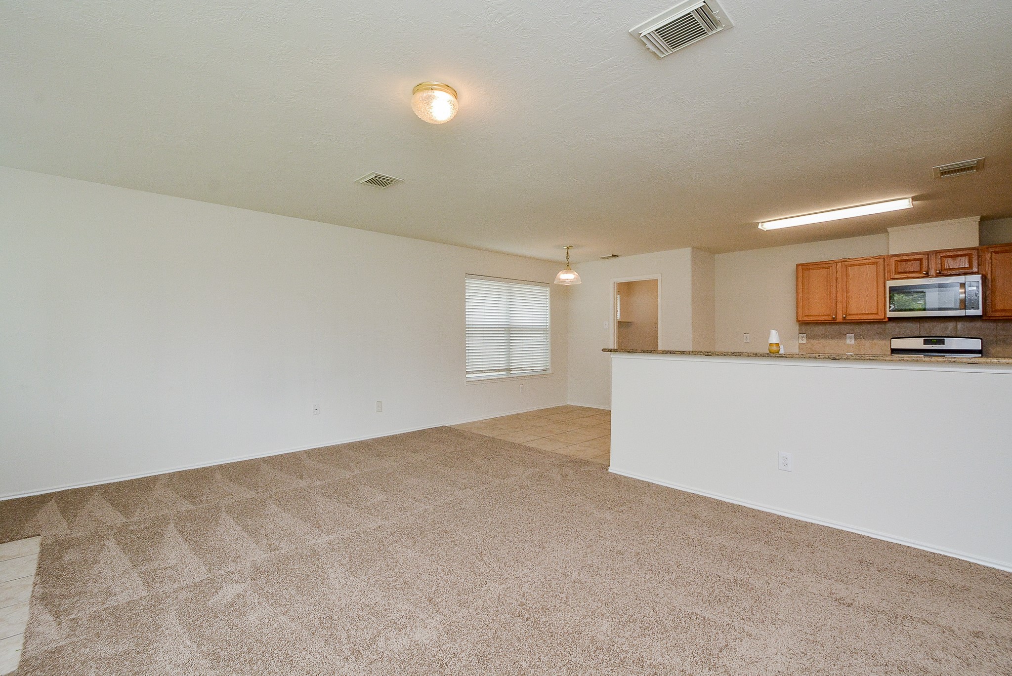 18326 Thicket Grove Road Houston, TX 77084 - Photo 12 of 50 a view of a kitchen and a dishwasher cabinets