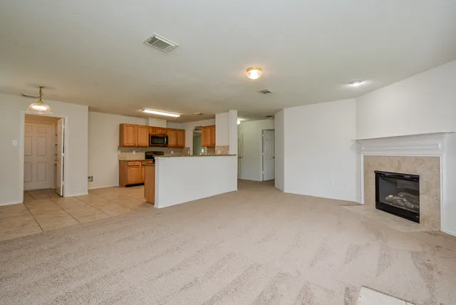 a view of a kitchen with a sink cabinets and a fireplace