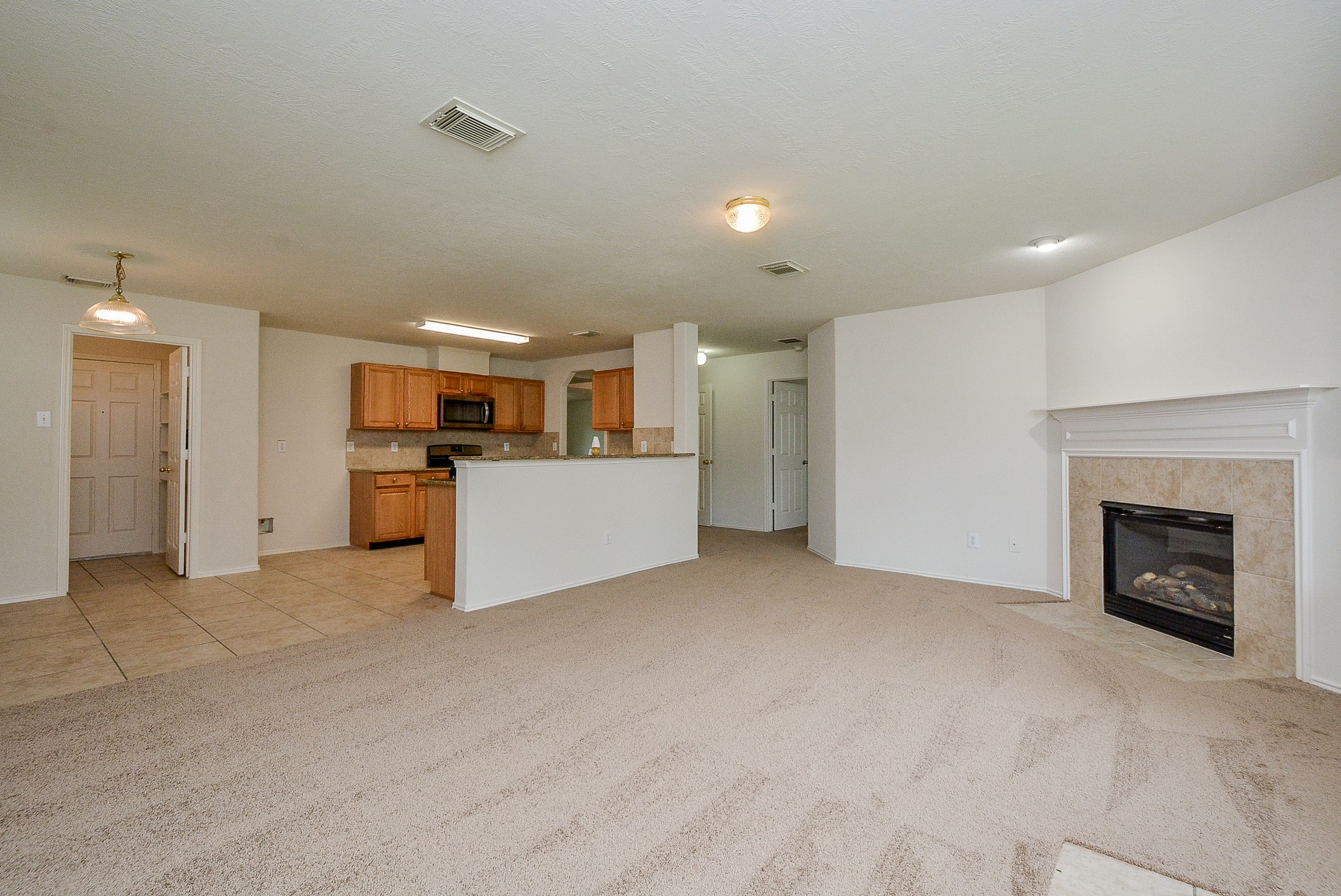 18326 Thicket Grove Road Houston, TX 77084 - Photo 13 of 50 a view of a kitchen with a sink cabinets and a fireplace