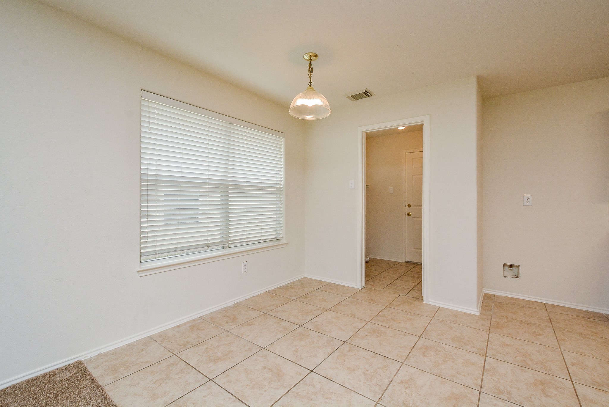 18326 Thicket Grove Road Houston, TX 77084 - Photo 15 of 50 a view of an empty room with window and chandelier fan