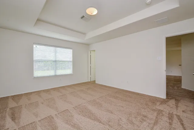 an empty room with windows and closet
