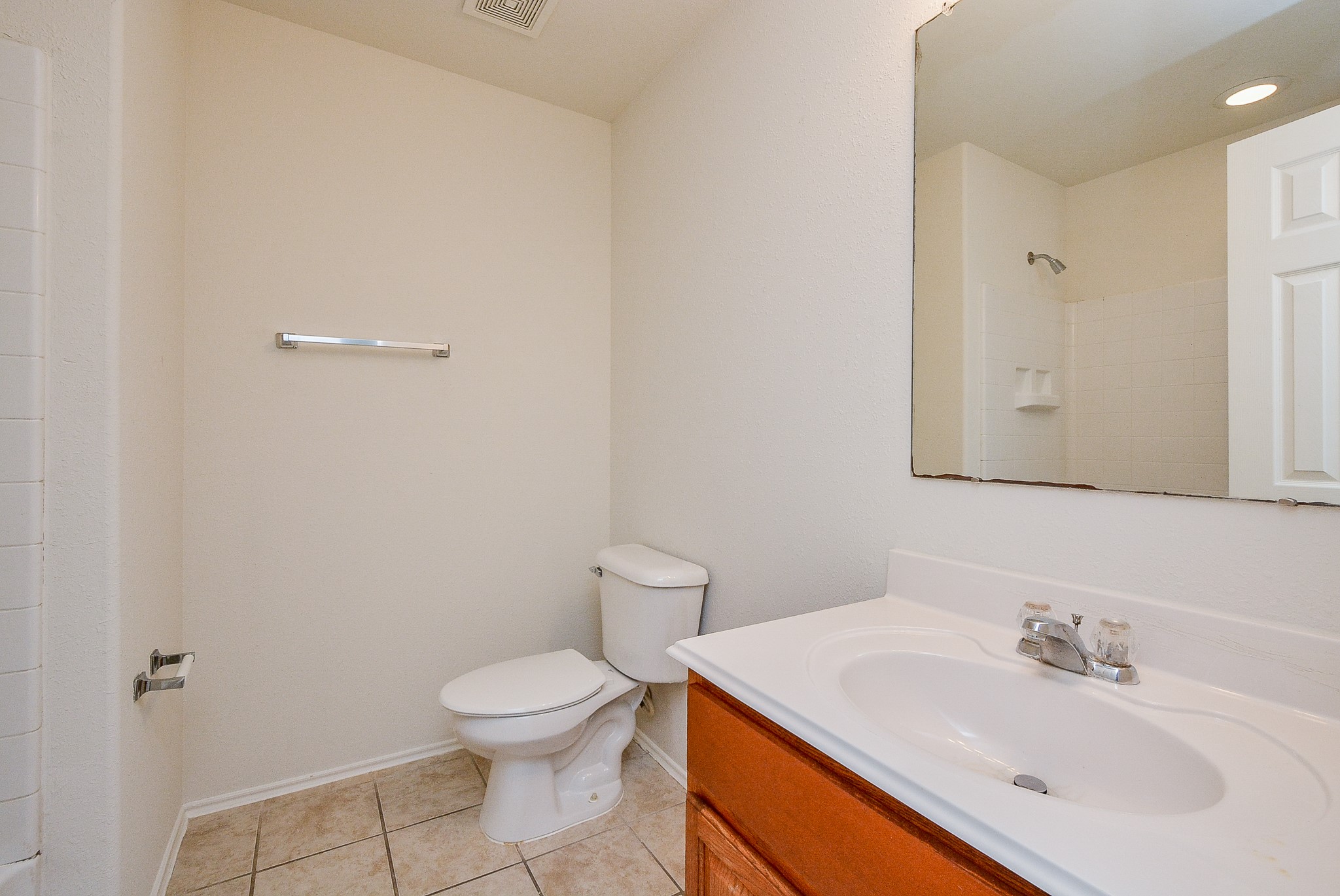 18326 Thicket Grove Road Houston, TX 77084 - Photo 33 of 50 a bathroom with a sink a toilet and mirror