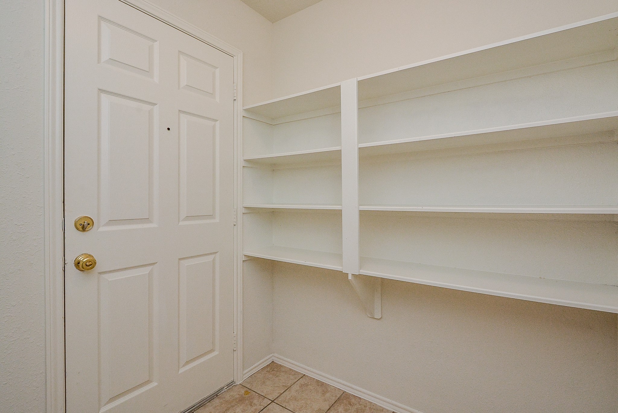 18326 Thicket Grove Road Houston, TX 77084 - Photo 41 of 50 a view of walk in closet with empty racks