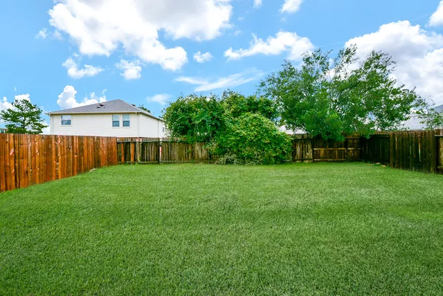 a view of a house with a backyard
