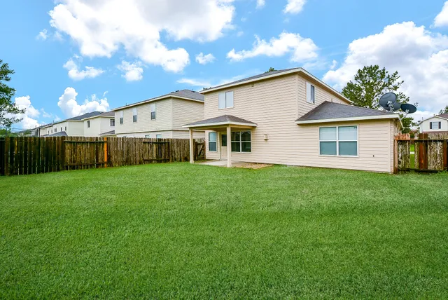 a view of a house with a backyard