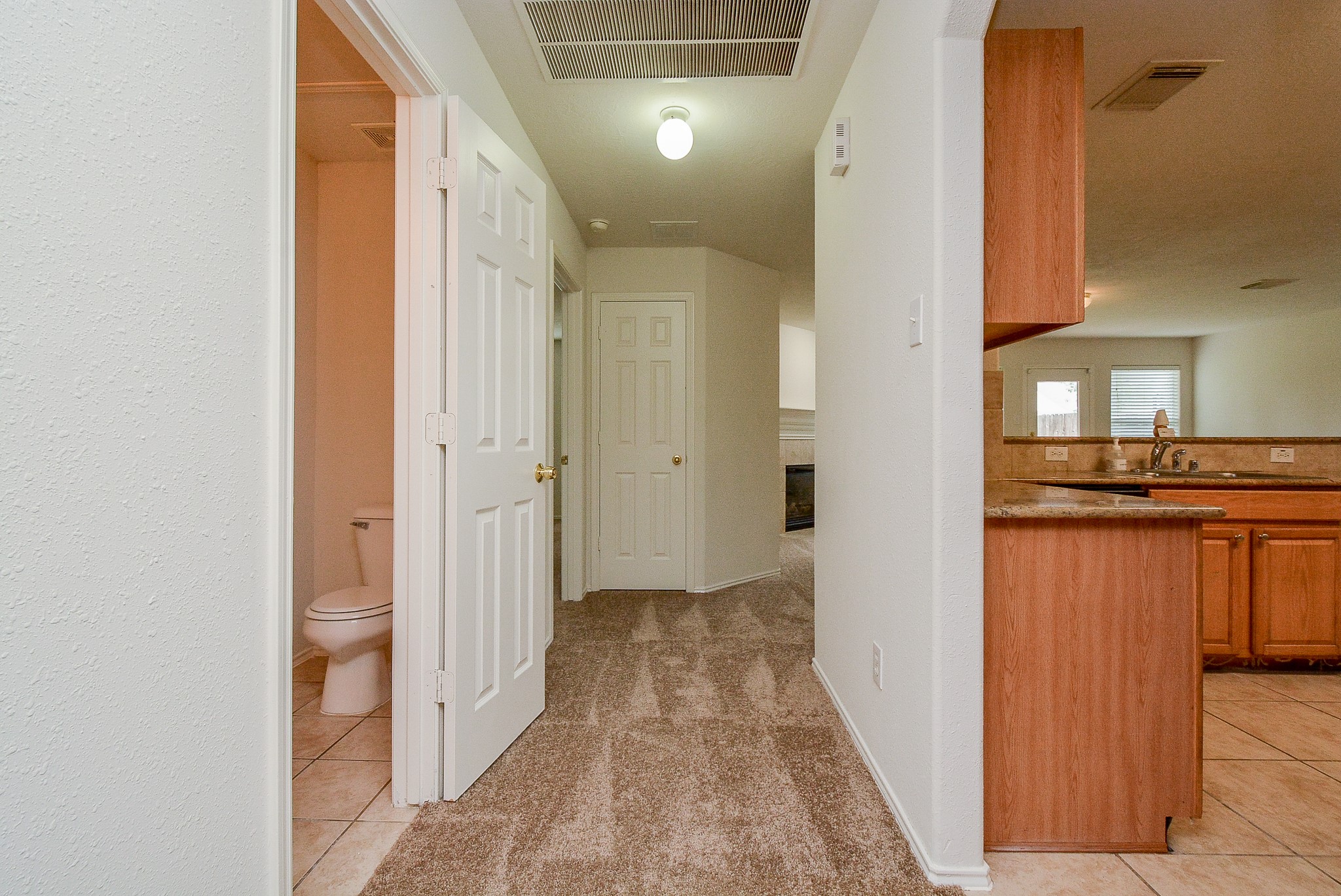 18326 Thicket Grove Road Houston, TX 77084 - Photo 10 of 50 a view of a hallway with wooden floor and a bathroom