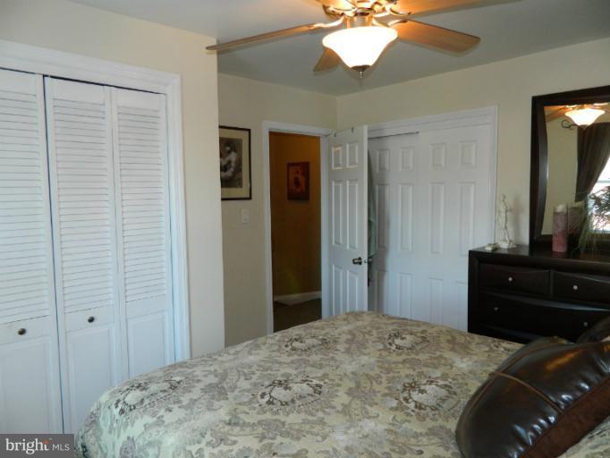 67 Garden Ridge Road Baltimore, MD 21228 - Photo 2 of 26 a bedroom with a bed and a dresser