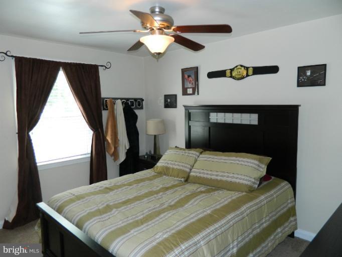 67 Garden Ridge Road Baltimore, MD 21228 - Photo 3 of 26 a bedroom with a bed and a window