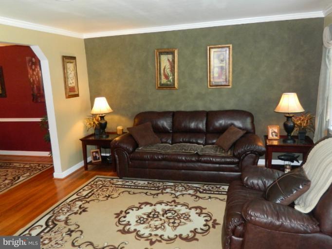 67 Garden Ridge Road Baltimore, MD 21228 - Photo 21 of 26 a living room with furniture and a fireplace