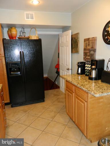 67 Garden Ridge Road Baltimore, MD 21228 - Photo 22 of 26 a kitchen with stainless steel appliances granite countertop a sink and a refrigerator