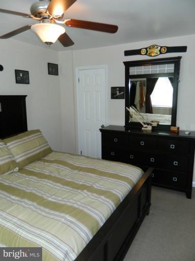 67 Garden Ridge Road Baltimore, MD 21228 - Photo 23 of 26 a bedroom with a bed and a dresser