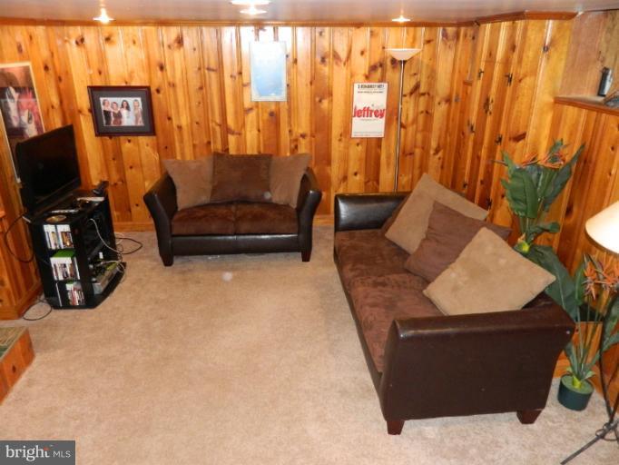 67 Garden Ridge Road Baltimore, MD 21228 - Photo 24 of 26 a living room with furniture and a flat screen tv