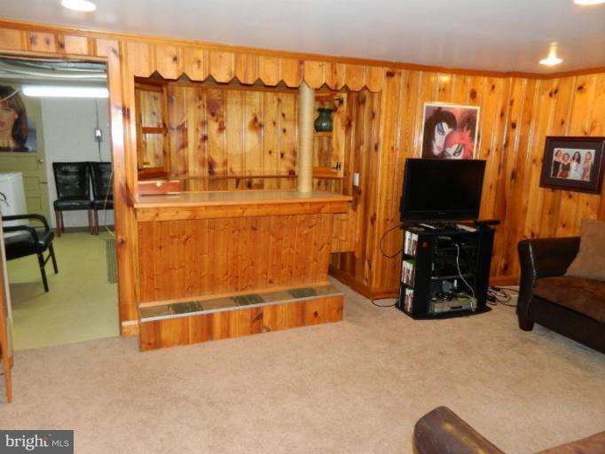 67 Garden Ridge Road Baltimore, MD 21228 - Photo 25 of 26 a room with gym equipment and a flat screen tv
