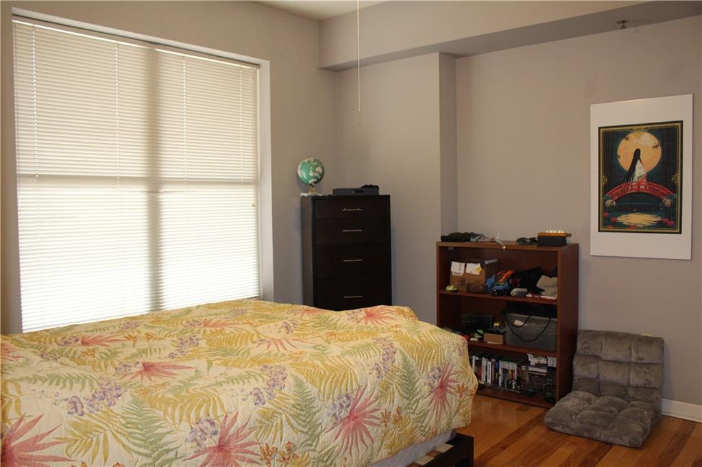 1101 Juniper Street Northeast, Unit 1416 Atlanta, GA 30309 - Photo 13 of 48 a bedroom with a bed and a window