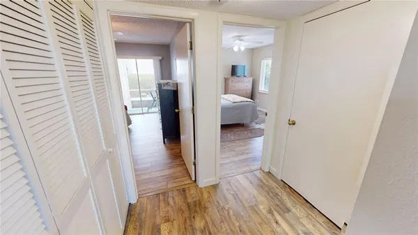 a bedroom with a bed a rug and wooden floor