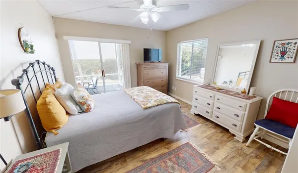 a view of a room with a large window and furniture