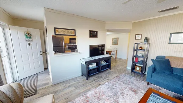 a living room with fireplace furniture and a wooden floor