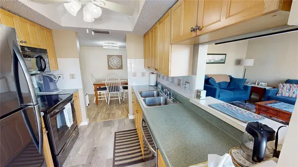 a kitchen with stainless steel appliances a refrigerator and a sink