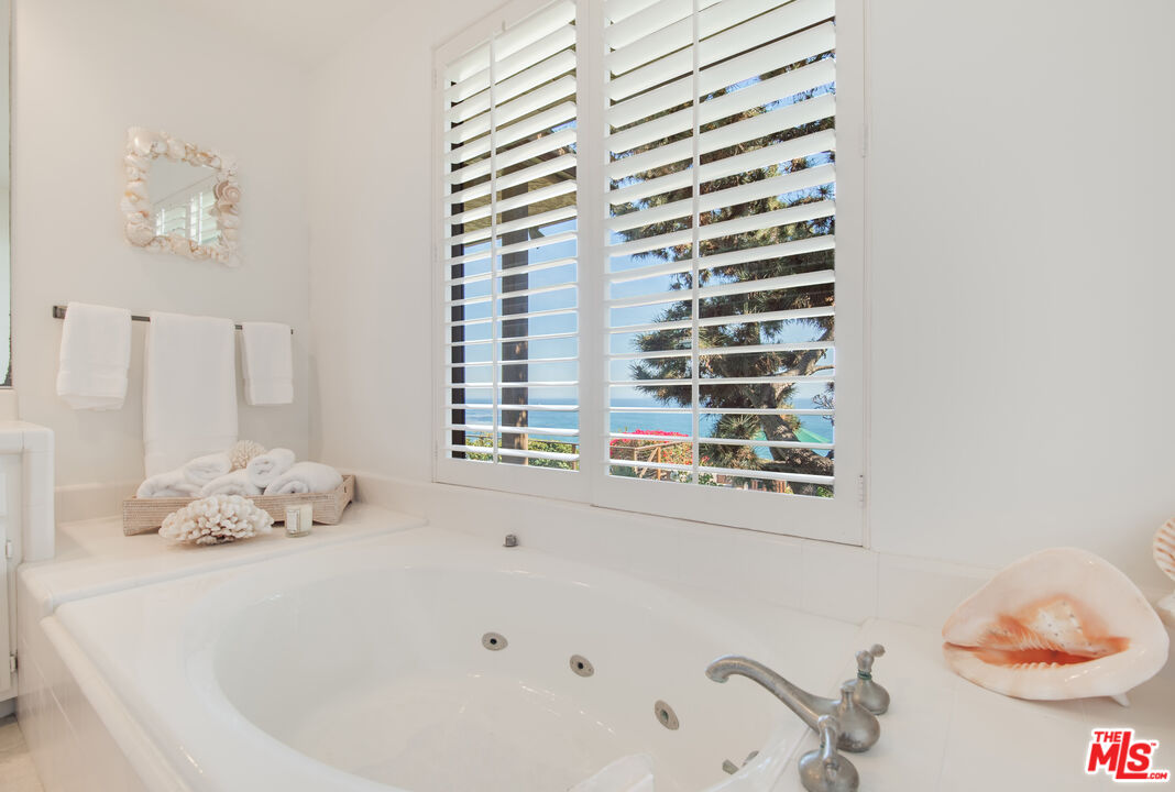 29008 Cliffside Drive Malibu, CA 90265 - Photo 22 of 28 a bathroom with a bathtub and a shower