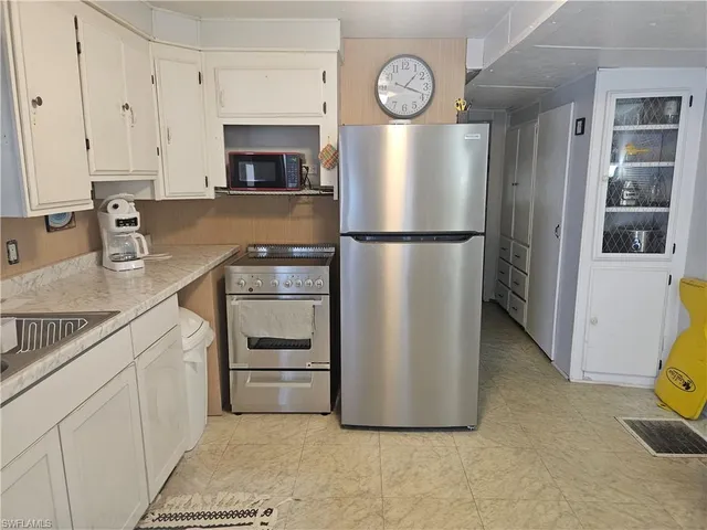 a kitchen with a refrigerator and a sink