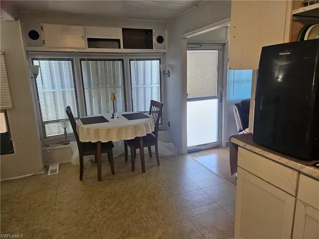 a dining room with furniture and window