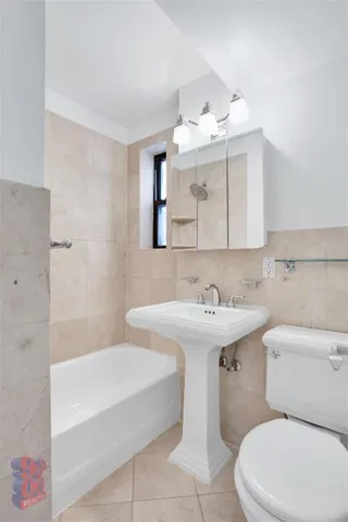 a bathroom with a sink a toilet and mirror