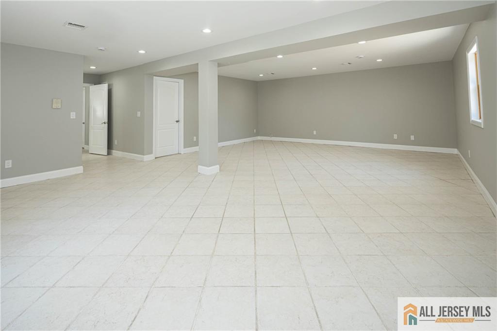 278 Rector Street Perth Amboy, NJ 08861 - Photo 31 of 47 an empty room with white walls and tiles