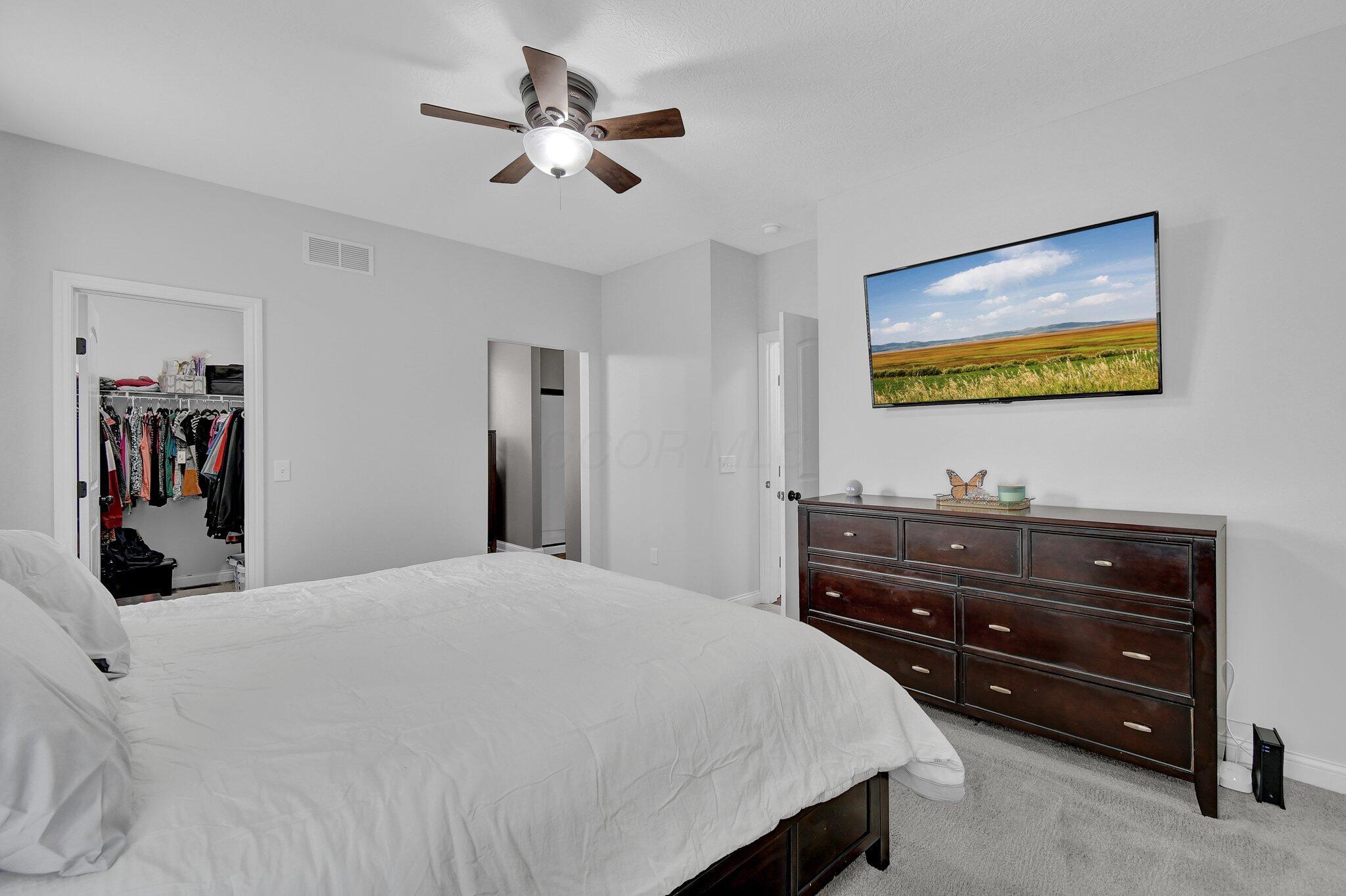 916 Rooks Circle Sunbury, OH 43074 - Photo 15 of 39 FIRST FLOOR primary bedroom has neutral decor, upgraded ceiling fan, large walk-in closet, and beautiful en-suite!