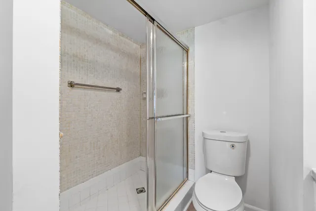 a bathroom with a toilet and a shower