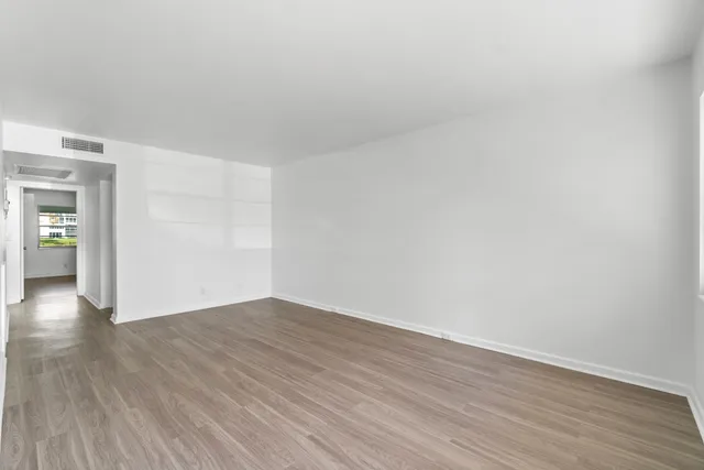 a view of an empty room and wooden floor