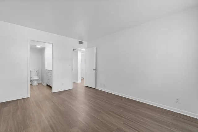 a view of a room with wooden floor and white doors