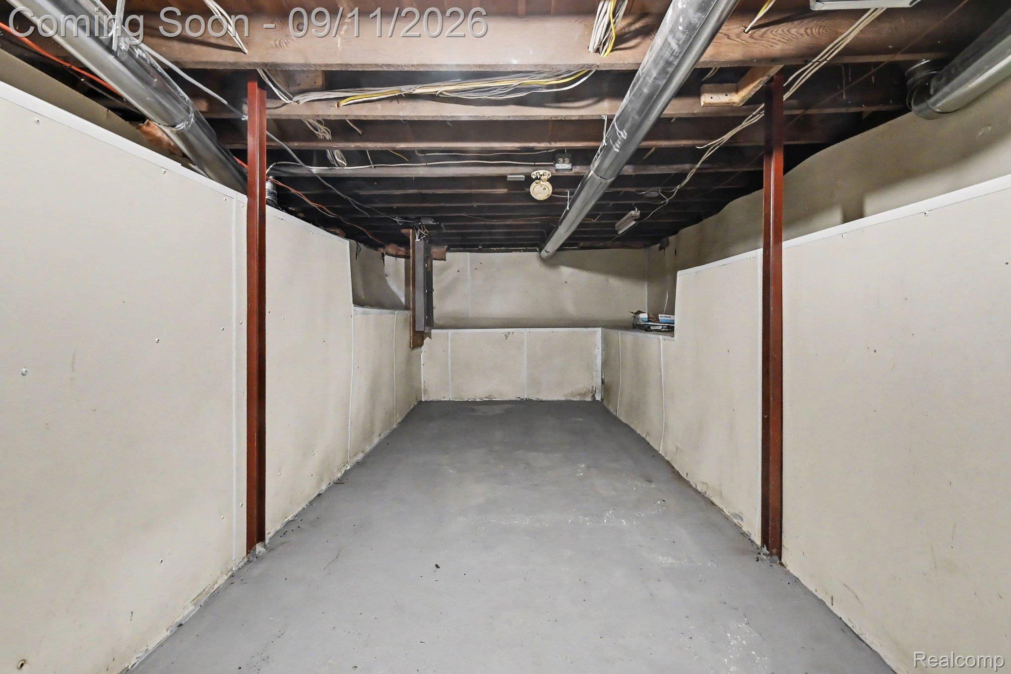409 Fleming Street Howell, MI 48843 - Photo 22 of 25 Unfinished basement with concrete flooring and partial wall paneling
