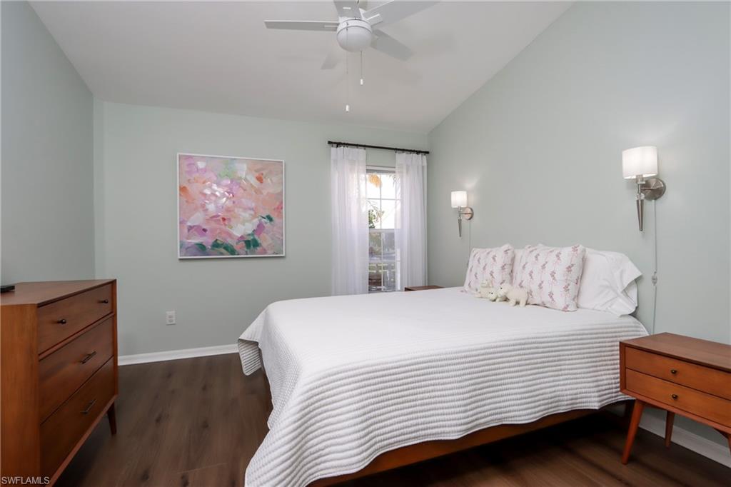 2585 Old Groves Road, Unit L203 Naples, FL 34109 - Photo 13 of 21 Bedroom with lofted ceiling, dark wood-style flooring, and ceiling fan
