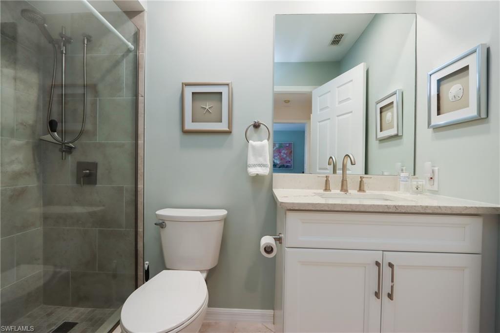 2585 Old Groves Road, Unit L203 Naples, FL 34109 - Photo 15 of 21 Bathroom featuring vanity and a stall shower