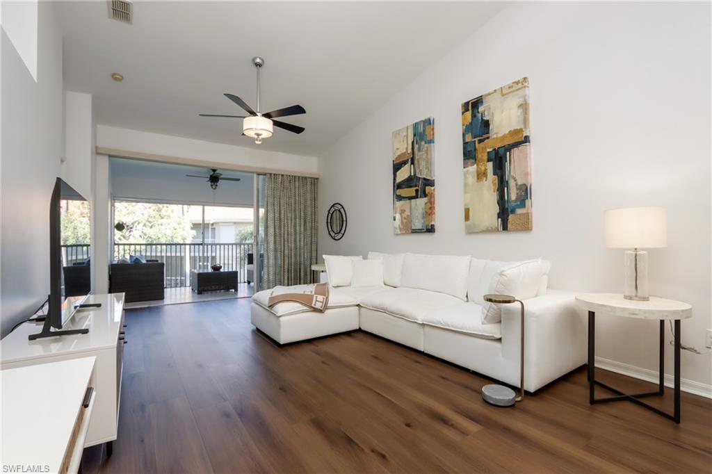 2585 Old Groves Road, Unit L203 Naples, FL 34109 - Photo 3 of 21 Living area with dark wood-style flooring and ceiling fan