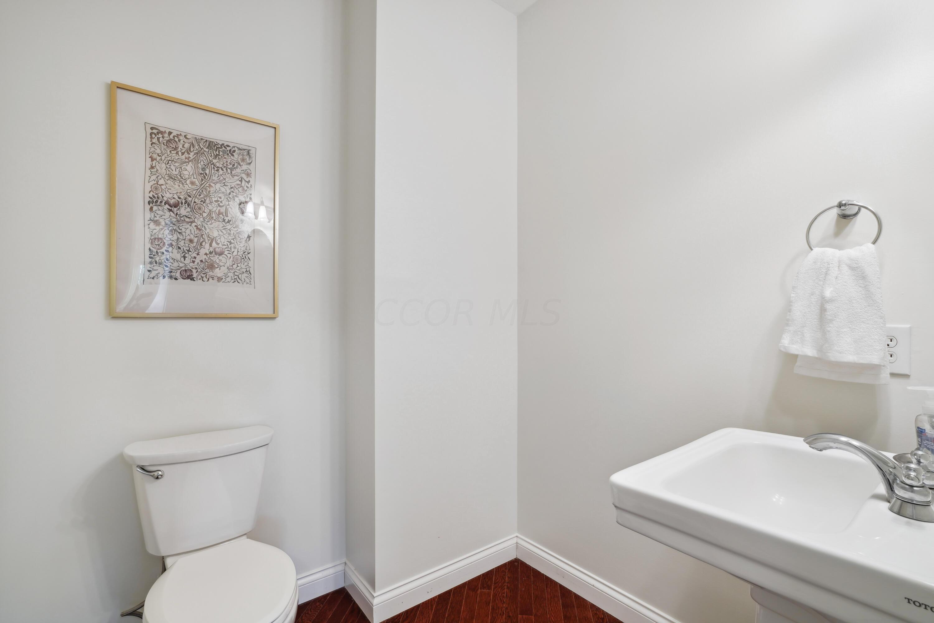 10403 Liberty Road Powell, OH 43065 - Photo 33 of 76 Pedestal sink and hardwood floors